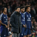 Ruben Amorim Manager / Head Coach of Manchester United stands with Leny Yoro, Marcus Rashford and Joshua Zirkzee as they wait to come on as substitutes during the Premier League match between Arsenal FC and Manchester United FC at Emirates Stadium on December 04, 2024 in London, England.
