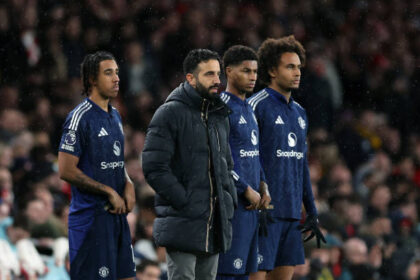 Ruben Amorim Manager / Head Coach of Manchester United stands with Leny Yoro, Marcus Rashford and Joshua Zirkzee as they wait to come on as substitutes during the Premier League match between Arsenal FC and Manchester United FC at Emirates Stadium on December 04, 2024 in London, England.