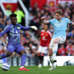 MANCHESTER, ENGLAND - APRIL 06: Andre Onana of Manchester United clears the ball under pressure from Kevin De Bruyne of Manchester City during the Premier League match between Manchester United FC and Manchester City FC at Old Trafford on April 06, 2025 in Manchester, England. (Photo by Michael Steele/Getty Images)